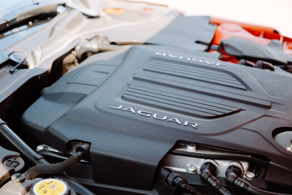 Detailed close-up of Jaguar car engine showcasing sleek design and advanced engineering.